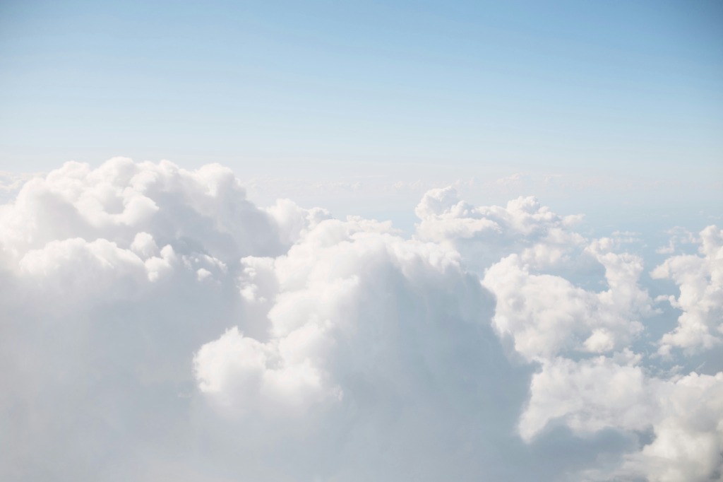 Soft white clouds in a blue sky representing digital peace and minimalism